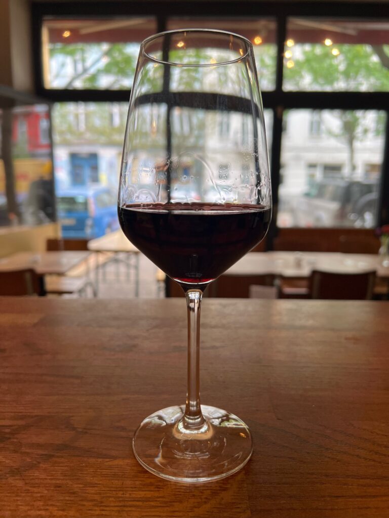 A glass of Italian red wine on the bar of an Italian pizza restaurant in Berlin. 