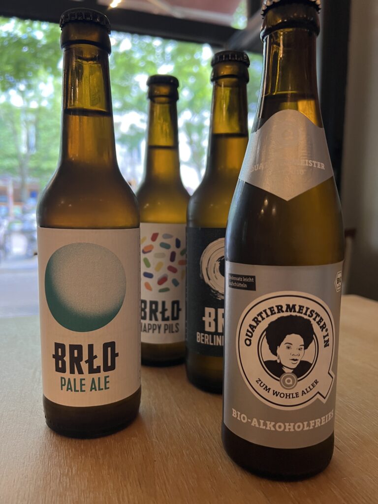 Bottles of local craft beer on the terrace of an Italian pizza restaurant in Berlin. 