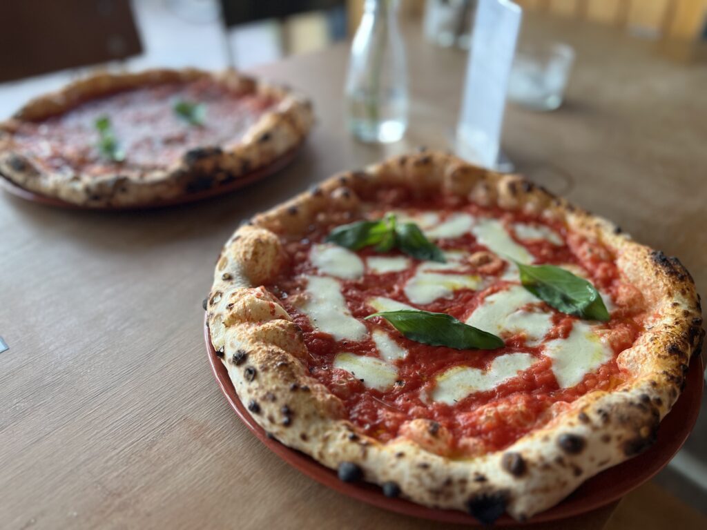 Authentic Neapolitan Margherita pizza with tomato sauce, mozzarella, and fresh basil at a Berlin pizzeria.